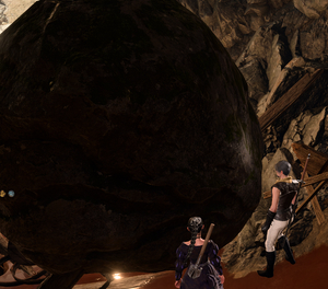 Ryker and Shadowheart looking at a giant rock that blocks off the exit to the cave they're in.